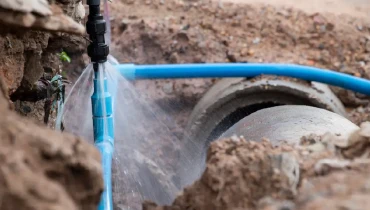 Photograph of a pipe burst underground.