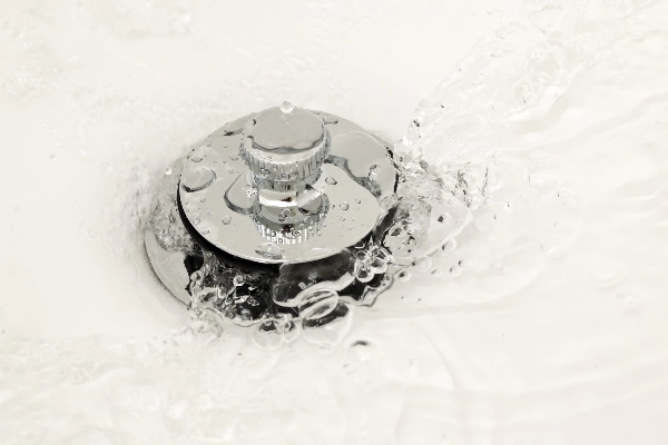 Water running down a bathtub drain.