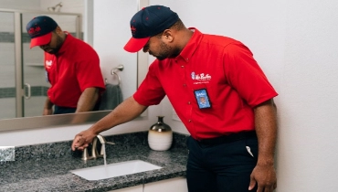 Mr. Rooter plumber tests water pressure