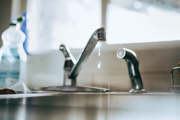 A dripping kitchen sink faucet.