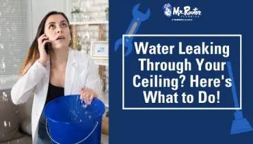 a women holding a bucket to catch water from ceiling leaks