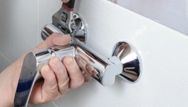 Installing a shower faucet.