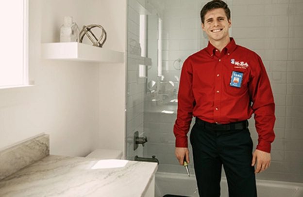 rooter worker standing in bathroom