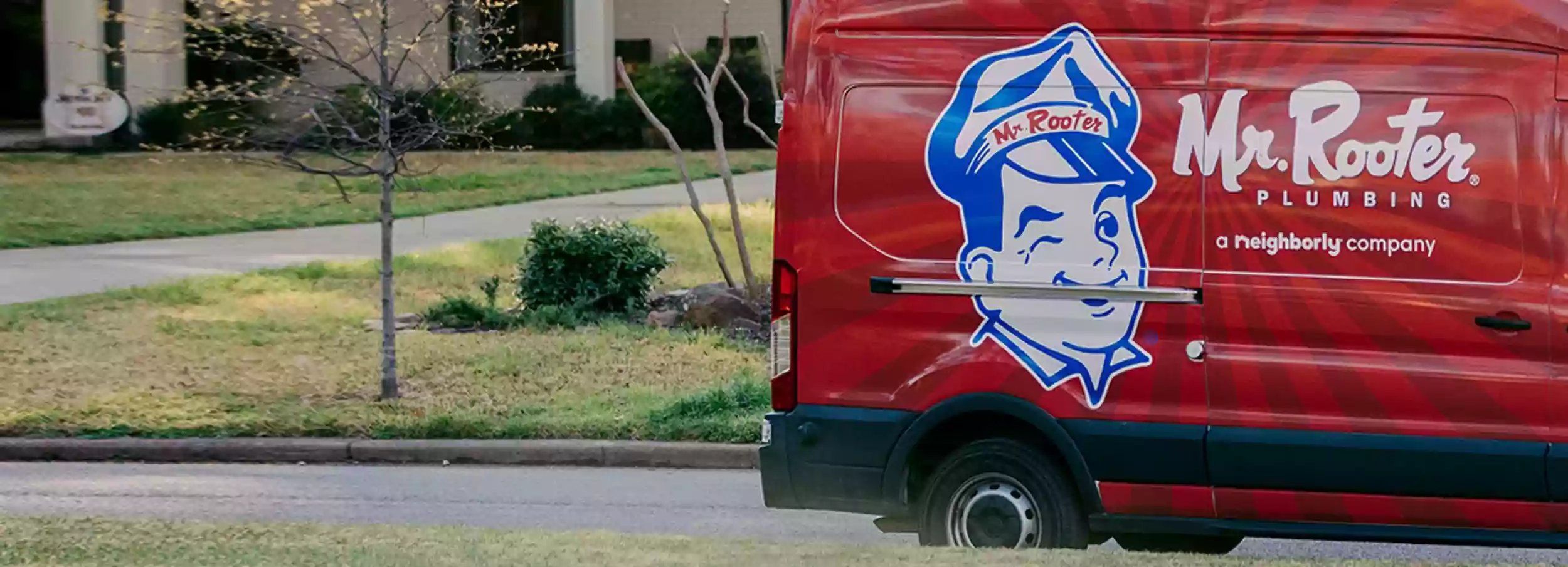 Closeup of the back of a red Mr. Rooter Plumbing van.