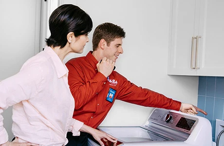 A Mr. Rooter plumber in Miamisburg, OH, discussing an appliance with a customer