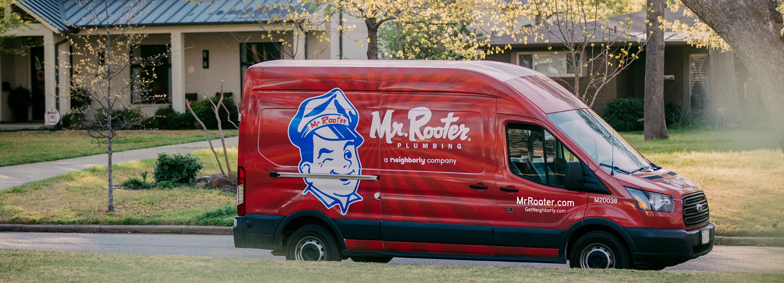 Mr. Rooter van outside a house.