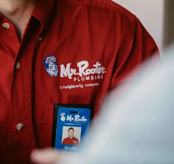 A Mr. Rooter of Fort Walton Beach Florida employee’s name tag on his shirt.