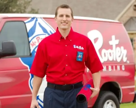 Mr. Rooter Technician walking up to the front door with protective mat.