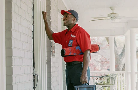 Mr. Rooter technician knocking on door.