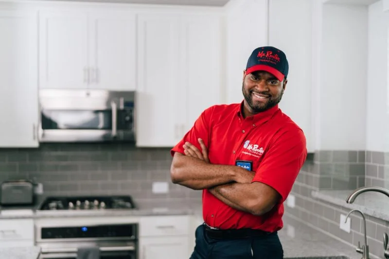 Mr. Rooter service professional ready to install tankless water heater.