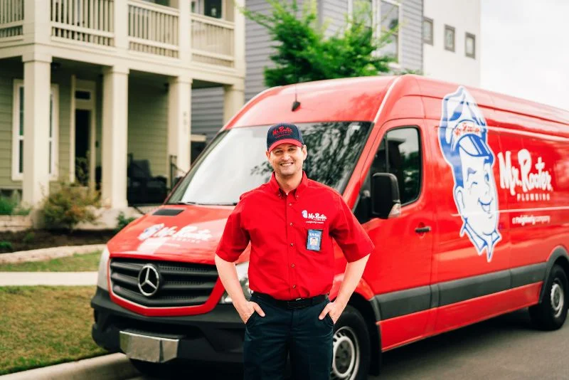 Mr. Rooter plumber standing in front of a work van before conducting a gas line replacement