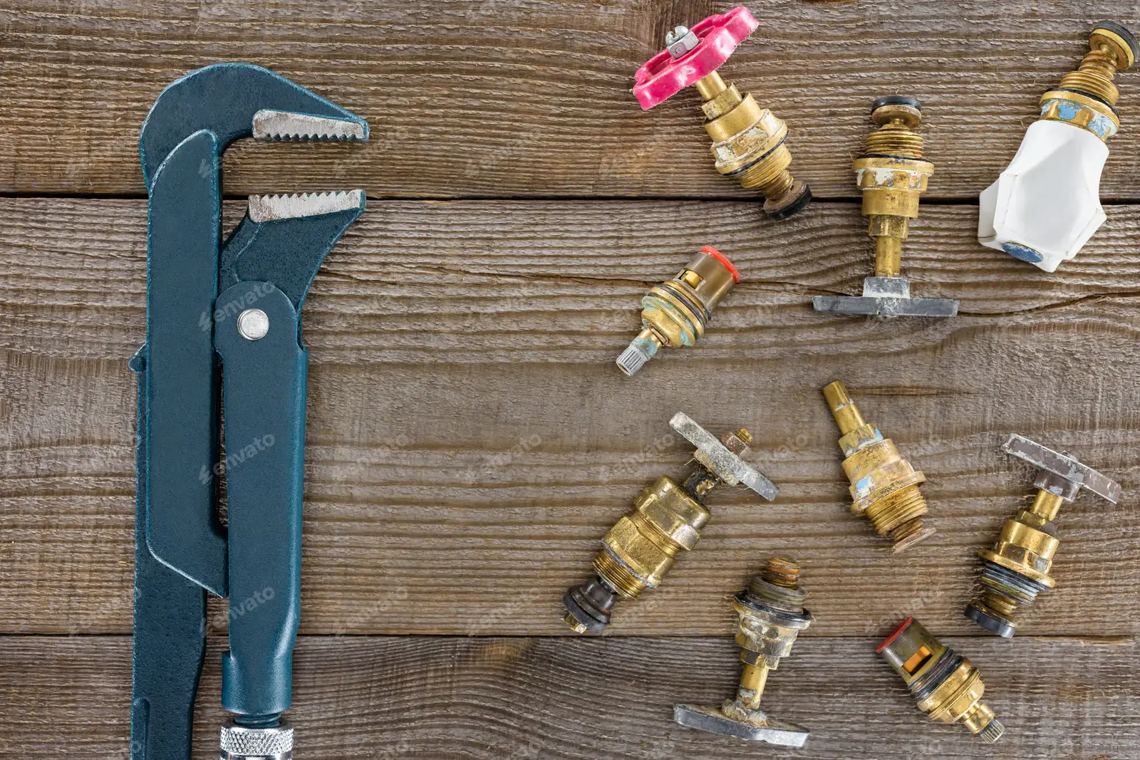 A selection of residential main water shut-off valves and a plumber’s wrench