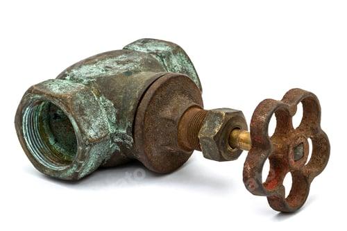 An old, rusty, and corroded main water shut-off valve