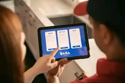 A Mr. Rooter Plumbing customer pointing at a "better" option on a plumber's tablet