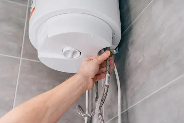 Plumber repairing a commercial electric water heater