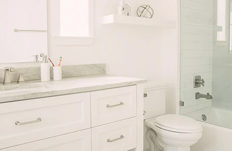 A bathroom with sink, toilet, and shower