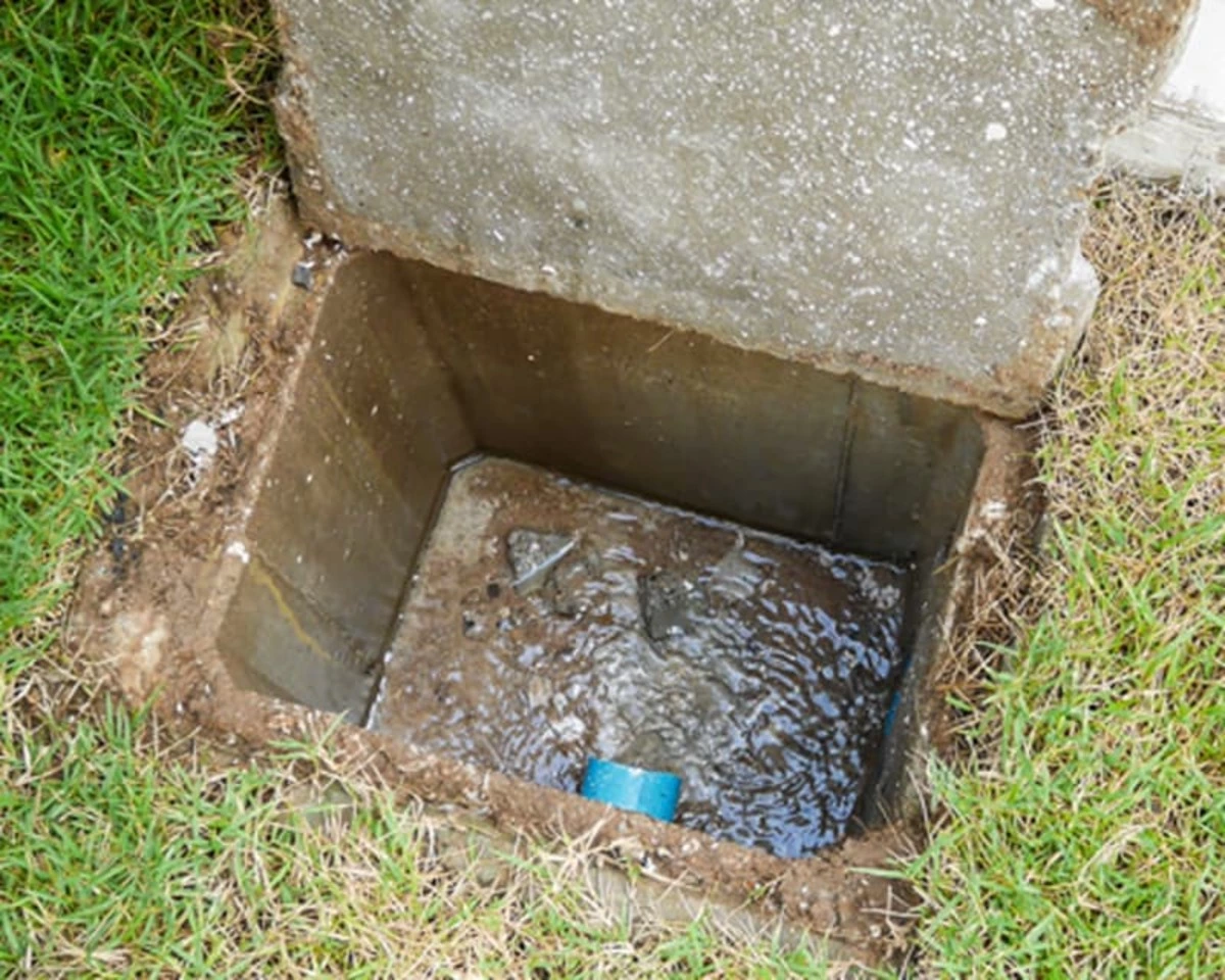 A Mr. Rooter Plumbing service professional accessing the main sewer line for pipe lining service in Memphis