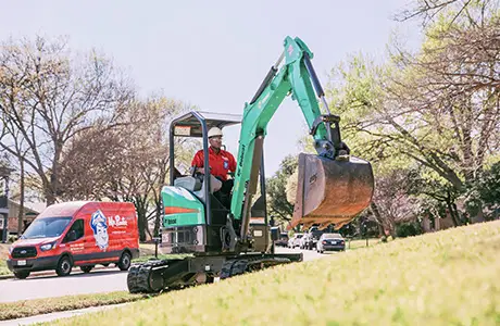 Mr. Rooter Plumber excavating a lawn