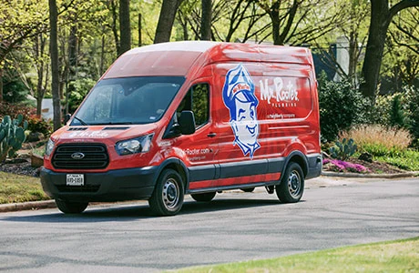 Mr. Rooter branded van parked on the street.