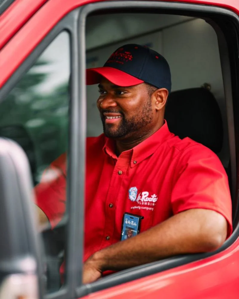 Mr. Rooter plumber driving to do commercial plumbing inspections.