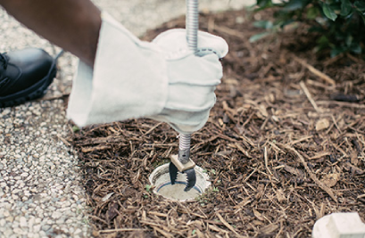 Plumber inserting tool into drain