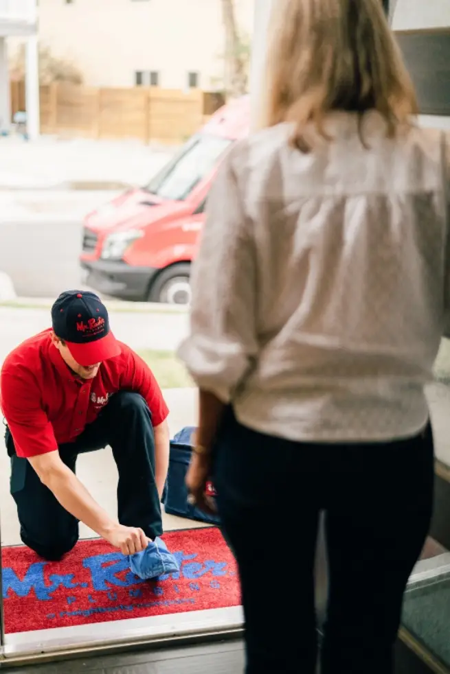 Mr. Rooter plumber preparing to enter a customer’s home