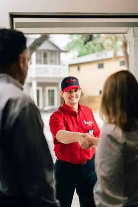 Mr. Rooter service professional greeting customers before water line repair service