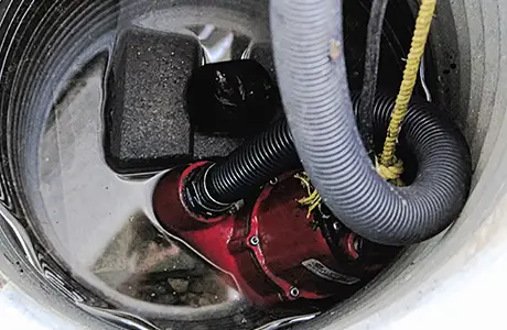 Water-surrounded sump pump during sump pump installation in Macon, GA