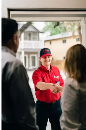 Mr. Rooter plumber greeting customers before water line repair service 