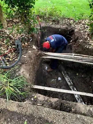 A Mr Rooter  repairing the sewer line