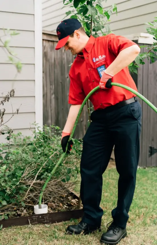 Mr. Rooter plumber using the hydroscrub-jetting tool