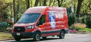 Red Mr. Rooter van parked on the street.