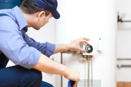 Virginia Beach plumber working on water heater