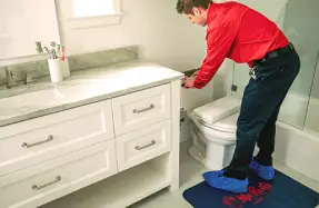 plumber repairing toilet