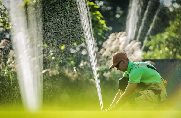 A service professional taking care of a sprinkler system repair.