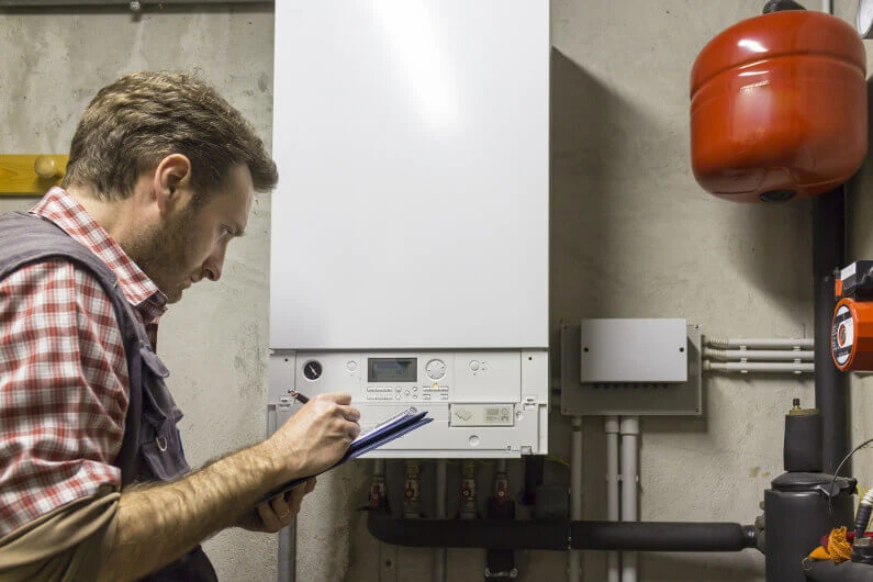 Plumber in San Marcos performing a tankless water heater installation.